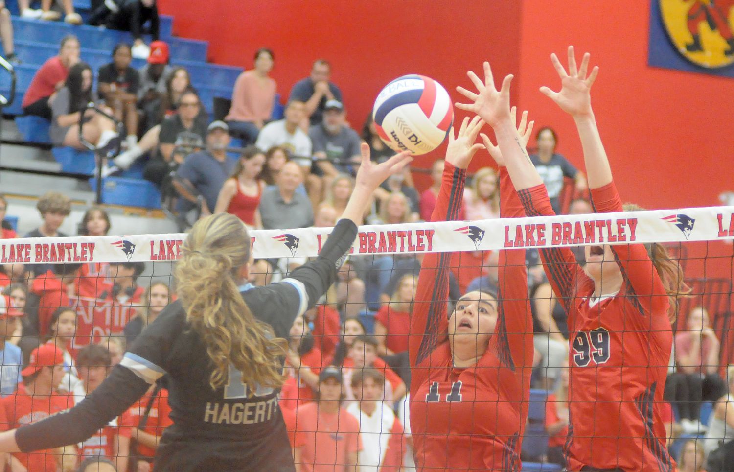 Lake Brantley blockers Austin Knight (17) and Sarah Gooch try to block Hagerty's Jenness Orcutt during their Region 1-7A final match. Knight ahd seven blocks, and Gooch had three blocks.